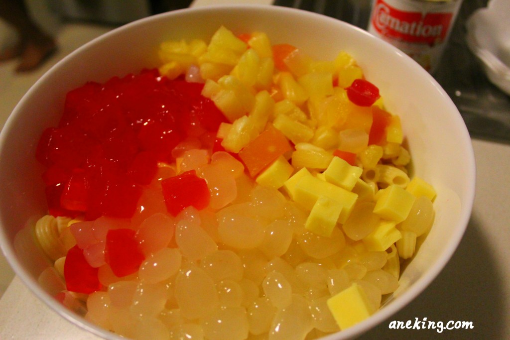 5. Add the fruit cocktail, small-cubed cheese, nata de coco and kaong in the mixture.
